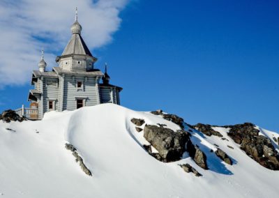 The wooden Trinity Church on King George Island in the snow