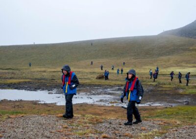 Hikers in barren northern landscape