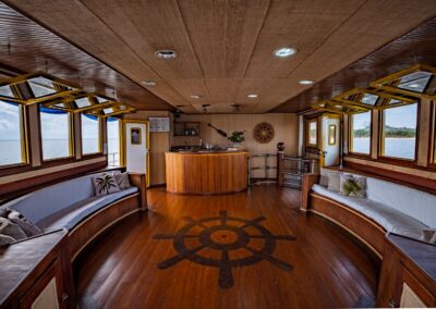 The Belle Amazon's bar and lounge area, featuring warm wood finishes