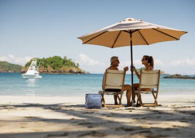 A picnic under a beach umbrella on a secluded beach