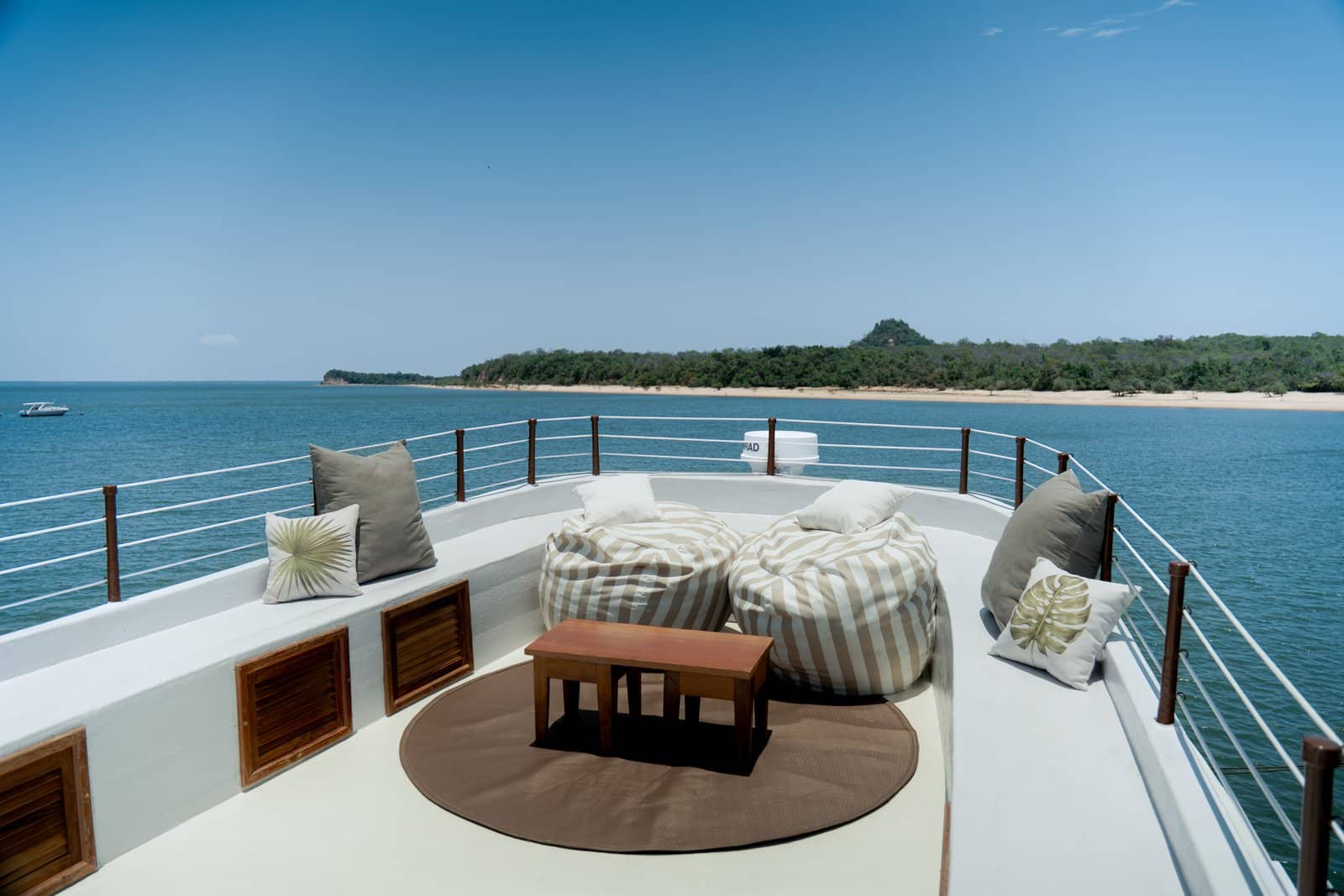 The Tupaiú's panoramic deck, featuring a seating area and views of the river and rainforest