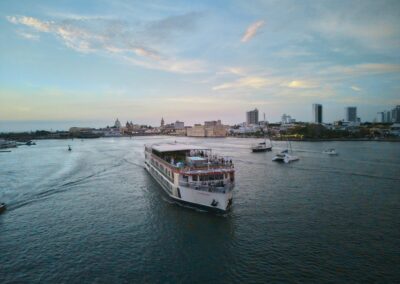 The AmaMelodia viewed from the stern, with the pool on the upper deck at dusk