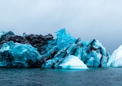 A shimmering blue iceberg in the sea off Greenland